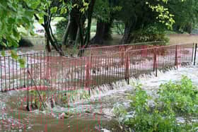 A bridge is swamped by flooding in Ashwood Park Buxton. Photo Jason Chadwick