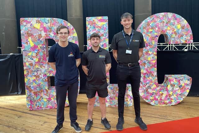 Aaron Woodward, Daniel Hallworth, and Eoin Jones standing in front of ‘BLC’ letters