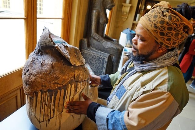 South African artist Andile Dyalvane with one of his ceramic works in the Chapel Corridor.