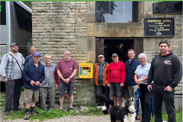 Members of Men's Shed and staff from Christeyns Professional Hygiene UK with the Whaley Bridge Canal Group mascot (dog, bottom right)