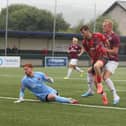 Jordan Burrow scores the opener for Buxton against Mickleover. Photo by Jason Chadwick.