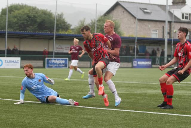 Jordan Burrow scores the opener for Buxton against Mickleover. Photo by Jason Chadwick.