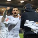 Diego de Girolamo (centre) is mobbed after scoring the winner for Buxton at York in the FA Cup. Photo: Richard Parkes.