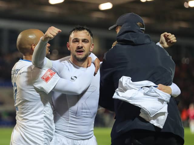 Diego de Girolamo (centre) is mobbed after scoring the winner for Buxton at York in the FA Cup. Photo: Richard Parkes.