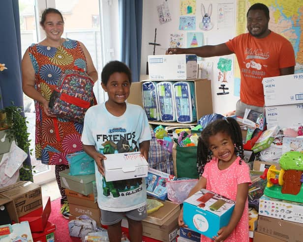 The Yordor family, Elvis, Kim, Nukie and Lorlor with the pile of supplies they are collecting to send to Ghana. Pic Jason Chadwick