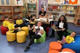 Author Matt Beighton with pupils of The Bemrose School in the new library