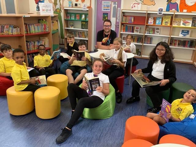 Author Matt Beighton with pupils of The Bemrose School in the new library