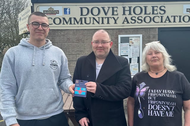 Robert Jones of Survive and Thrive accepts a £100 gift card for Buxton Aldi, from Buxton resident and High Peak Comps' Callen Deighan.