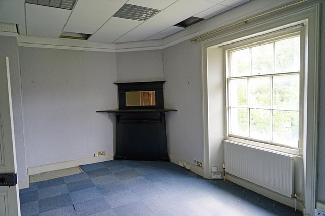 Fixtures and fittings from the bank have long been stripped out but this corner cabinet remains. A letter box marked Quick Deposit in one of the other rooms is one of the few reminders of the building's former use.
