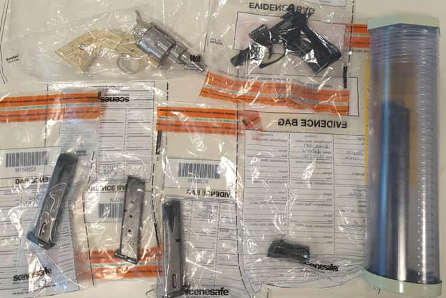 A photo taken by officers shows evidence bags filled with handgun casings, and ammunition magazines.