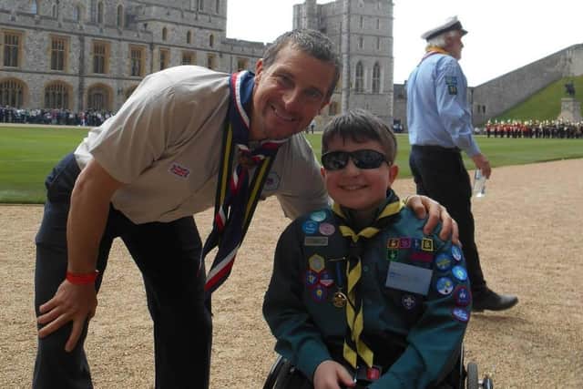 Peter Berriman pictured with Bear Grylls at Windsor Castle after being awarded the Chief Scout's Commendation for Meritorious Conduct award.