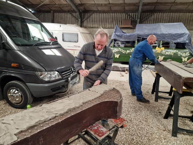 New wet clay being pressed in to the boards and then smoothed off