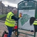 Two volunteers cleaning up the sign at the bottom of The Slopes. Pic Buxton Town Team
