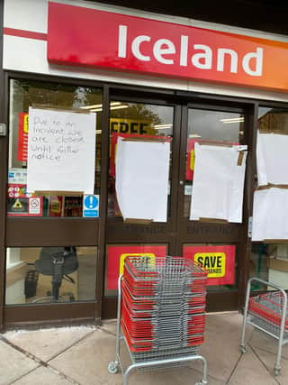 A handwritten note outside Buxton's Iceland supermarket says it is closed due to an incident
