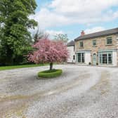An attractive frontage with large bay windows and a central doorway .
