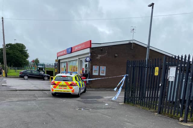 A police cordon at the One Stop shop.