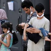Afghan refugees are being evacuated from Kabul after the Taliban takeover. Photo by Olivier DOULIERY via Getty Images.