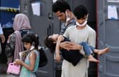 Afghan refugees are being evacuated from Kabul after the Taliban takeover. Photo by Olivier DOULIERY via Getty Images.