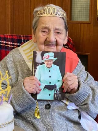 Marion, 100, proudly shows her telegram from The Queen.