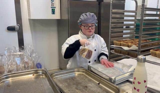 Meg Williams, has been taken on a full time employee after finishing her supported internship at Buxton Pudding Emporium. Photo Buxton and Leek College