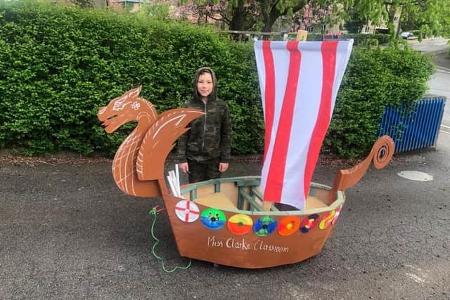 Oliver Lukasik with the Viking longboat he built for his school project