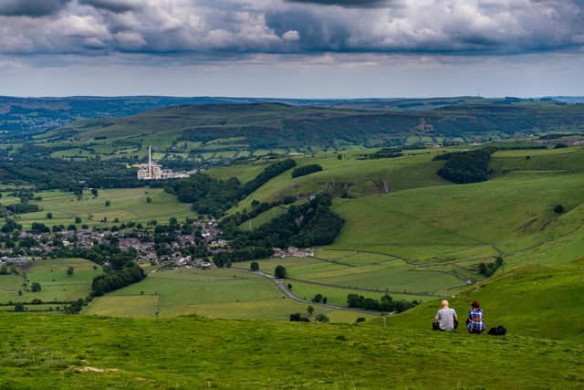 A couple admires the view from the top of Mam Tor with Hope Cement Works standing out on the landscape. Picture: James Hardisty.