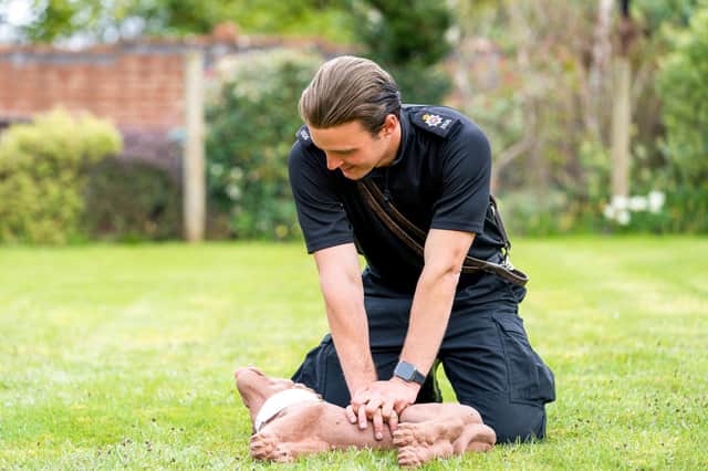 A Police Dog Handler practicing Dog First Aid on a CPR dummy dog.