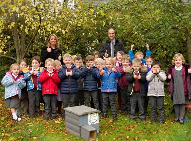 Whaley Bridge Primary school class accepting hedgehog house from Biodiversity Whaley group.