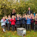Taxal and Fernilee Primary school accepting hedgehog house from Biodiversity Whaley group.