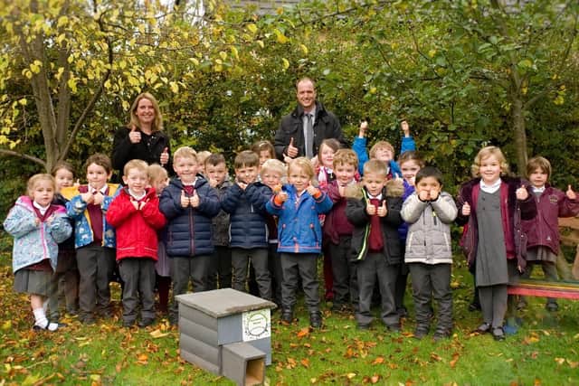 Taxal and Fernilee Primary school accepting hedgehog house from Biodiversity Whaley group.