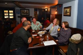 Drinkers at the Old Sun Inn in Buxton on May 17 when pubs reopened for indoor service. (Photo by Nathan Stirk/Getty Images)