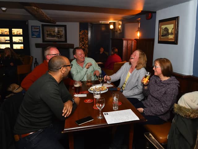 Drinkers at the Old Sun Inn in Buxton on May 17 when pubs reopened for indoor service. (Photo by Nathan Stirk/Getty Images)