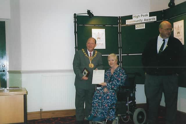 Linda Downings receives her High Peak Community award, with James, right, and the mayor.