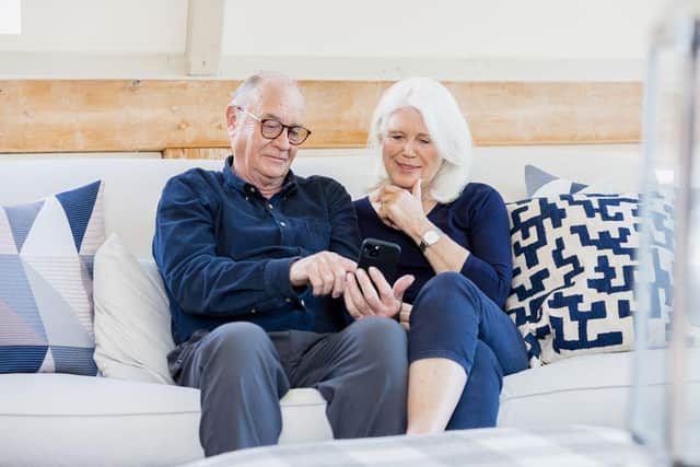 Married couple looking at smartphone - copyright SafeKeep