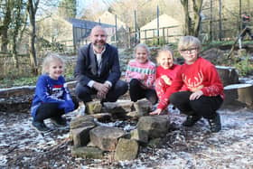 Buxworth Primary Head Paul Bertram with Florence, Millie, Poppy and William in one of their outdoor teaching spaces