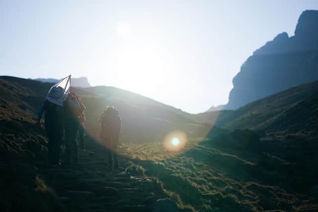 The Three Peaks Challenge is a professionally organised expedition which involves 42 kilometres of walking and 3,000 metres of ascents. Hikers usually scale at least one of the peaks in darkness. ((Photo by Ian Forsyth/Getty Images)
