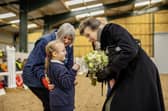 Rider Emmie Wakerley (6) presents a posy to HRH The Princess Royal, assisted by Deborah Ward, Secretary, Helen Atkin Group Buxton RDA. Photo David John King