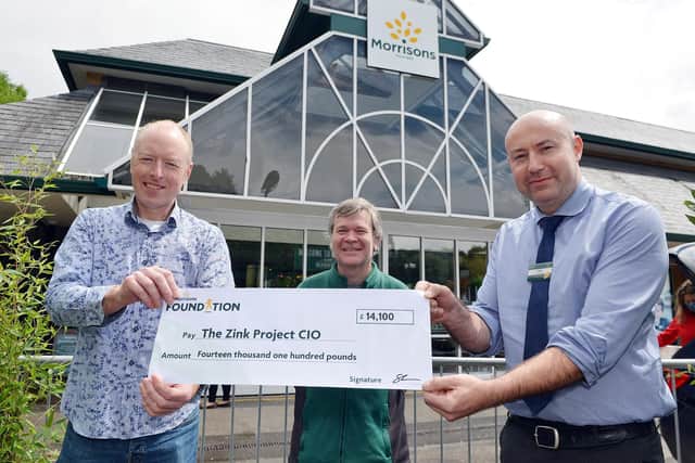 Zink project presented with money from the Morrisons store in Buxton. Paul Bohan ceo zink charity, Rob Harrison community champion and store manager Chris Denby.