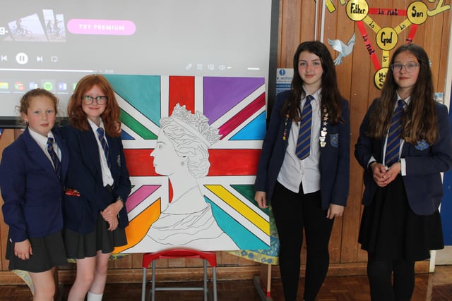 Pupils at Fairfield Endowed Junior School with a colourful Union Jack flag.