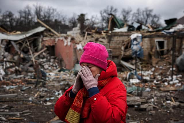 A Ukrainian woman despairs after her home was bombed in March 2022. Photo - Getty Images