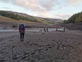 Members of Edale Mountain Rescue are pictured helping a stricken walker from the mud at Ladybower reservoir. Pictures: Edale Mountain Rescue