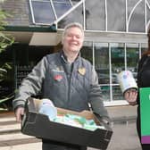 Morrisons Community Champion Rob Harrison hands over baby milk and other supplies to Kirsty Jackson of High Peak Baby Bank. Photo Jason Chadwick