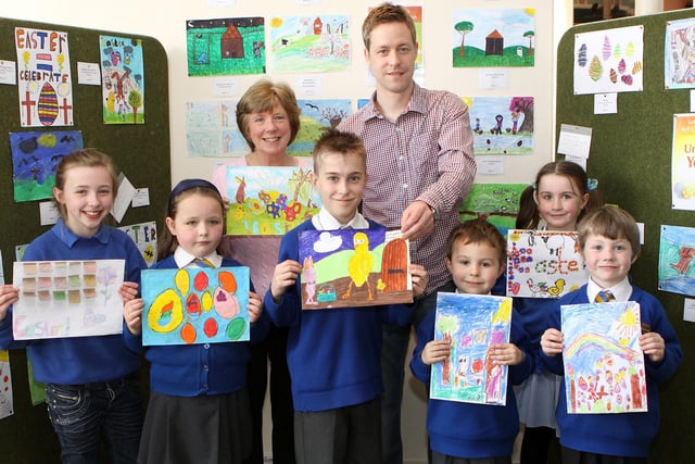Easter art competition winners Georgia Walker, Emily Henshaw, Henry Nuttall, Bradley Dungworth, Jaedon Green and  Millie Wharmby with artist Rob Wilson and organiser Christine Marrison pictured back in 2011. Photo Jason Chadwick