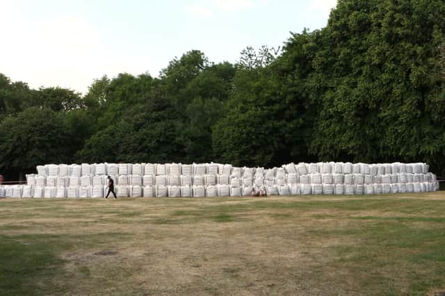 The sandbag levee being built in a New Mills park as a set for ITV's After the Flood 