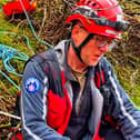 Ropes were used to rescue the 'inquisitive' spaniel who got stuck and its two owners. Pic submitted