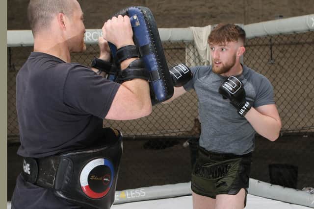 Tyler Spencer at work in the gym with his coach Jon  Santry. Pic Jason Chadwick