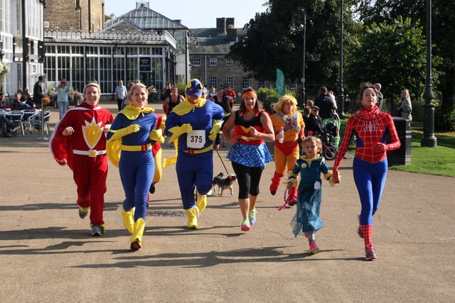 The superheroes on the run in front of the pavilion.
