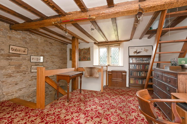 The farmhouse has four bedrooms and four attic rooms - this area pictured being currently in use as a study or library.