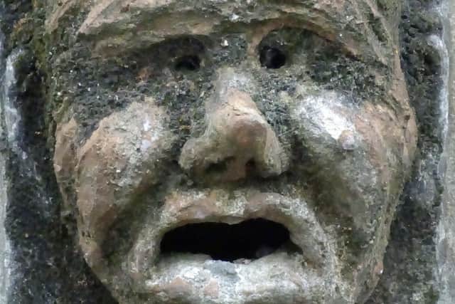 One of two grotesques on the Old Courthouse which pulls a grimace - intensified by a terracotta tinge