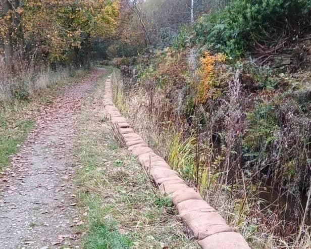 A community payback scheme will see up to 2,500 sandbags being filled and reinstalled around Toddbrook Reservoir.